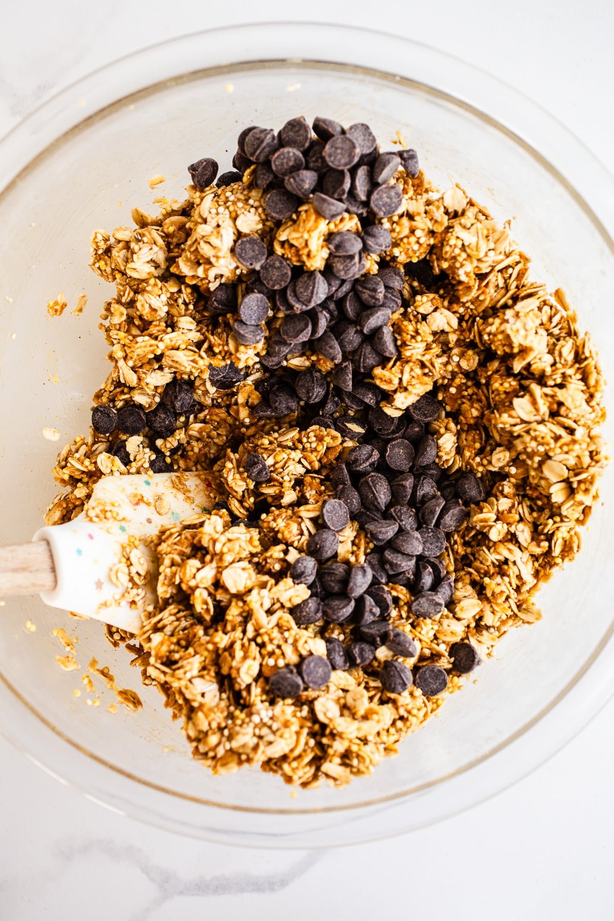 Oats, peanut butter, and chocolate chips in a mixing bowl.