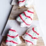 White chocolate Christmas tree cakes on a marbled platter.