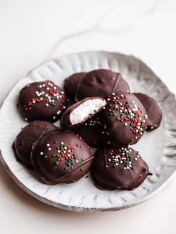 Chocolate peppermint patties on a white plate.