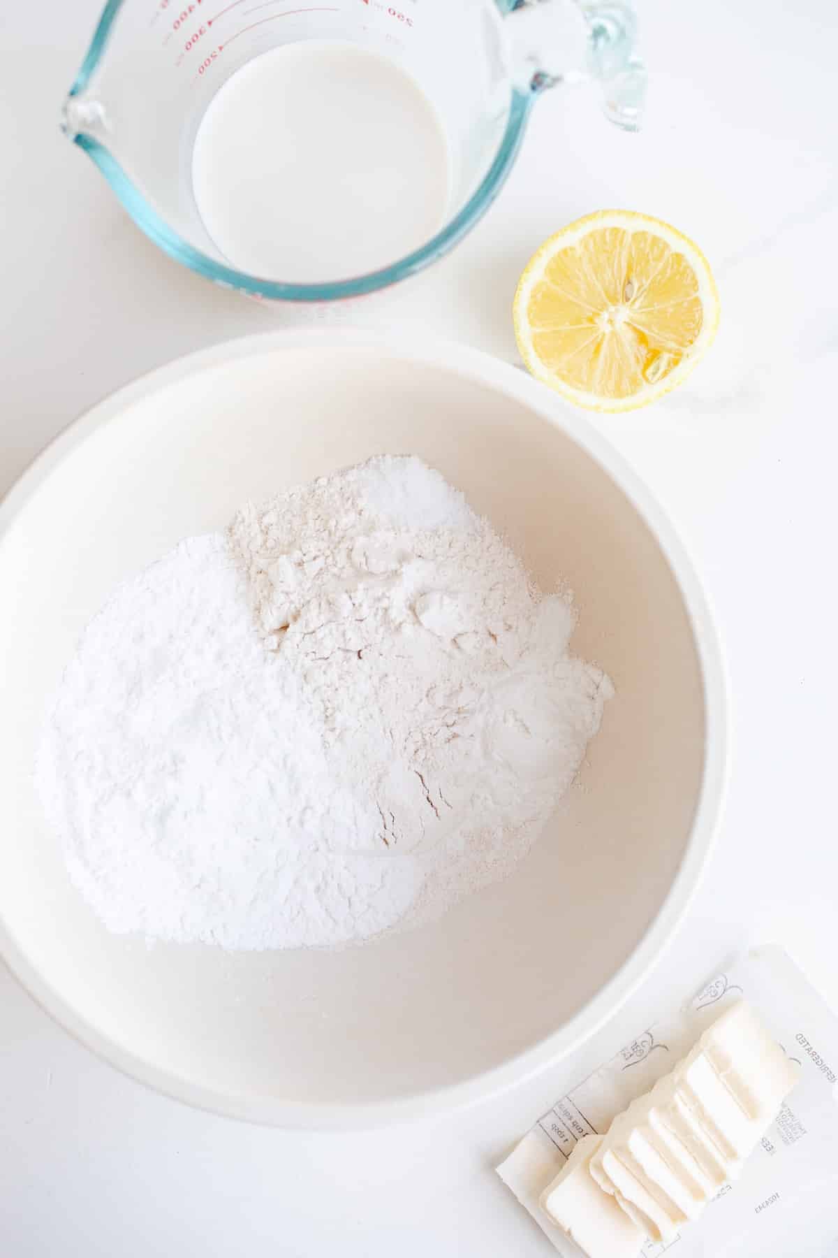 Ingredients to make biscuits in small bowls.
