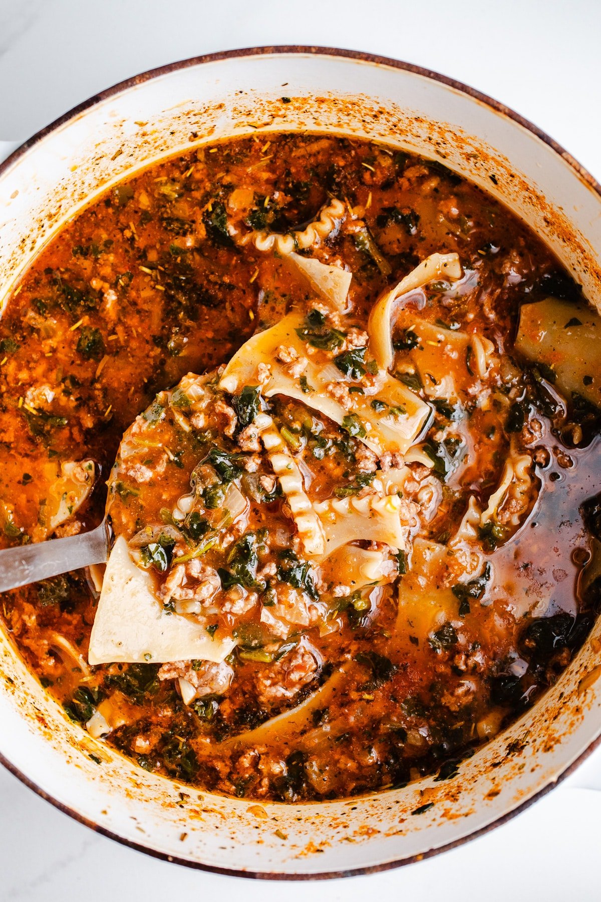 Lasagna soup in a white pot. 