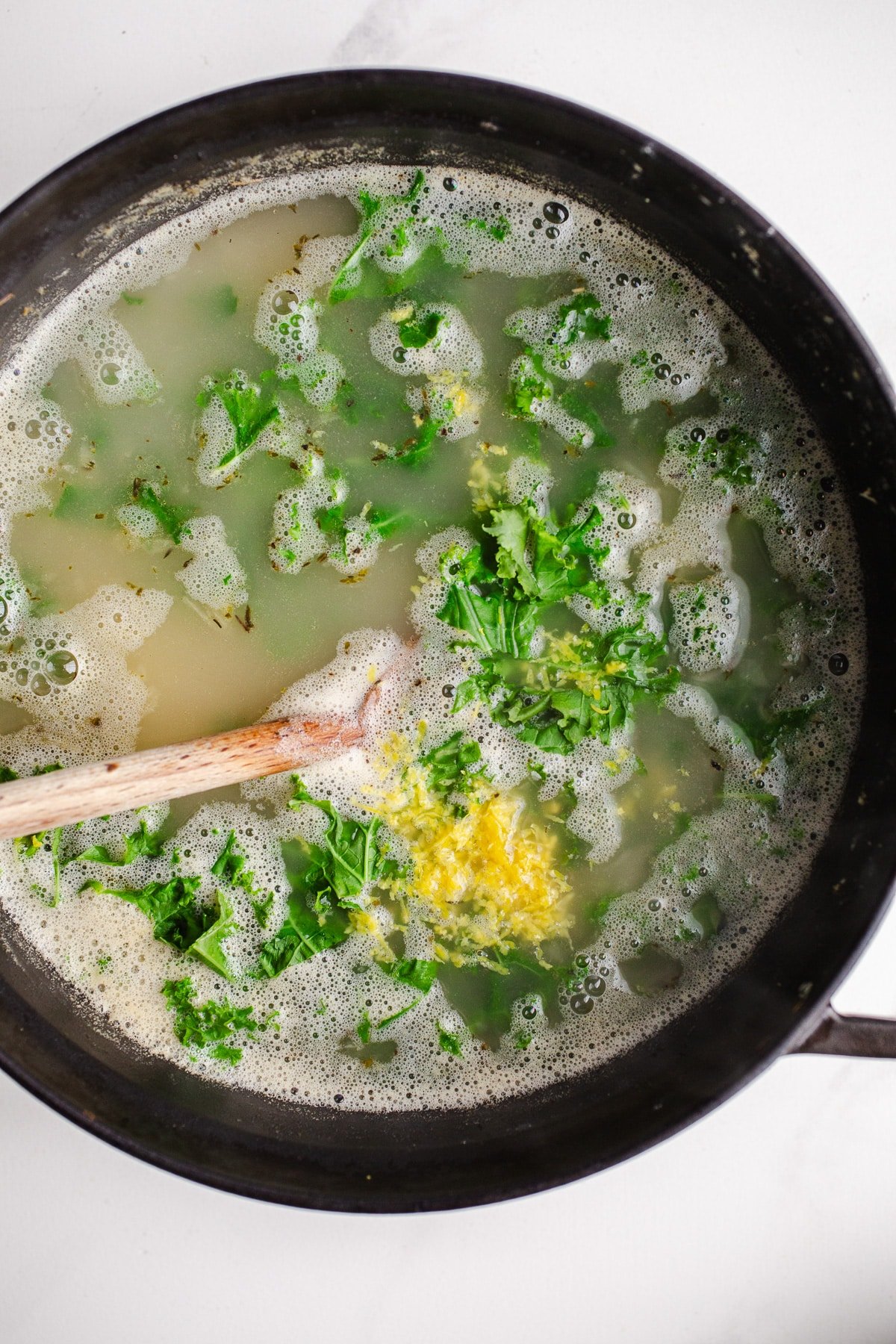 Kale and lemon zest in a large pot.