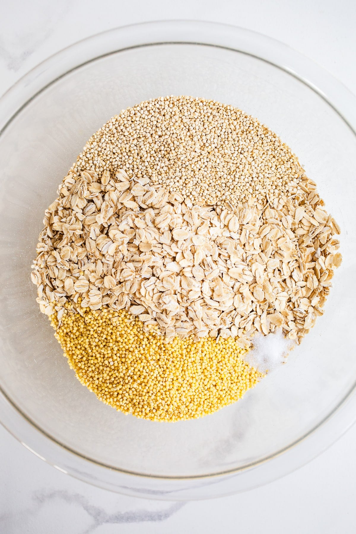 Oats and seeds in a glass mixing bowl.