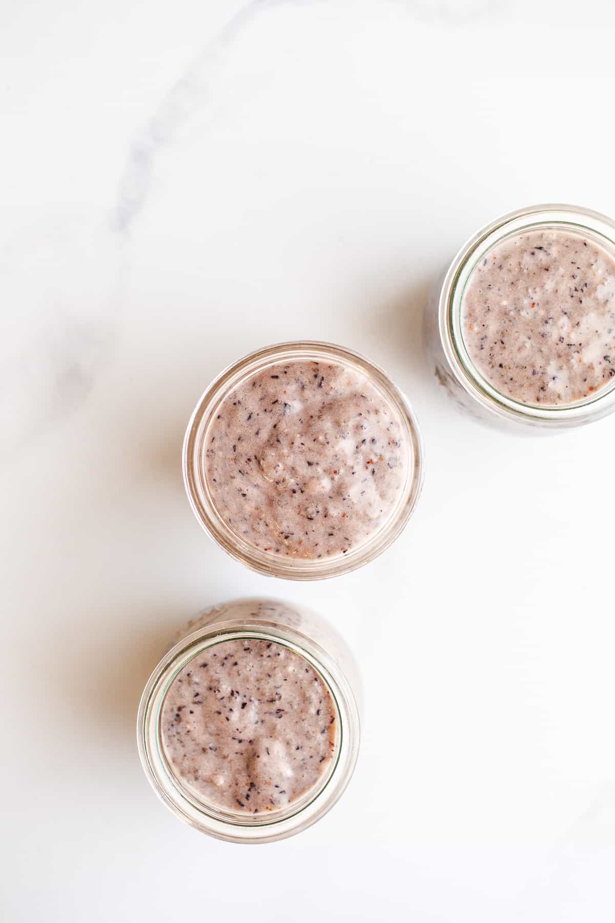 Blueberry chia pudding in small mason jars.