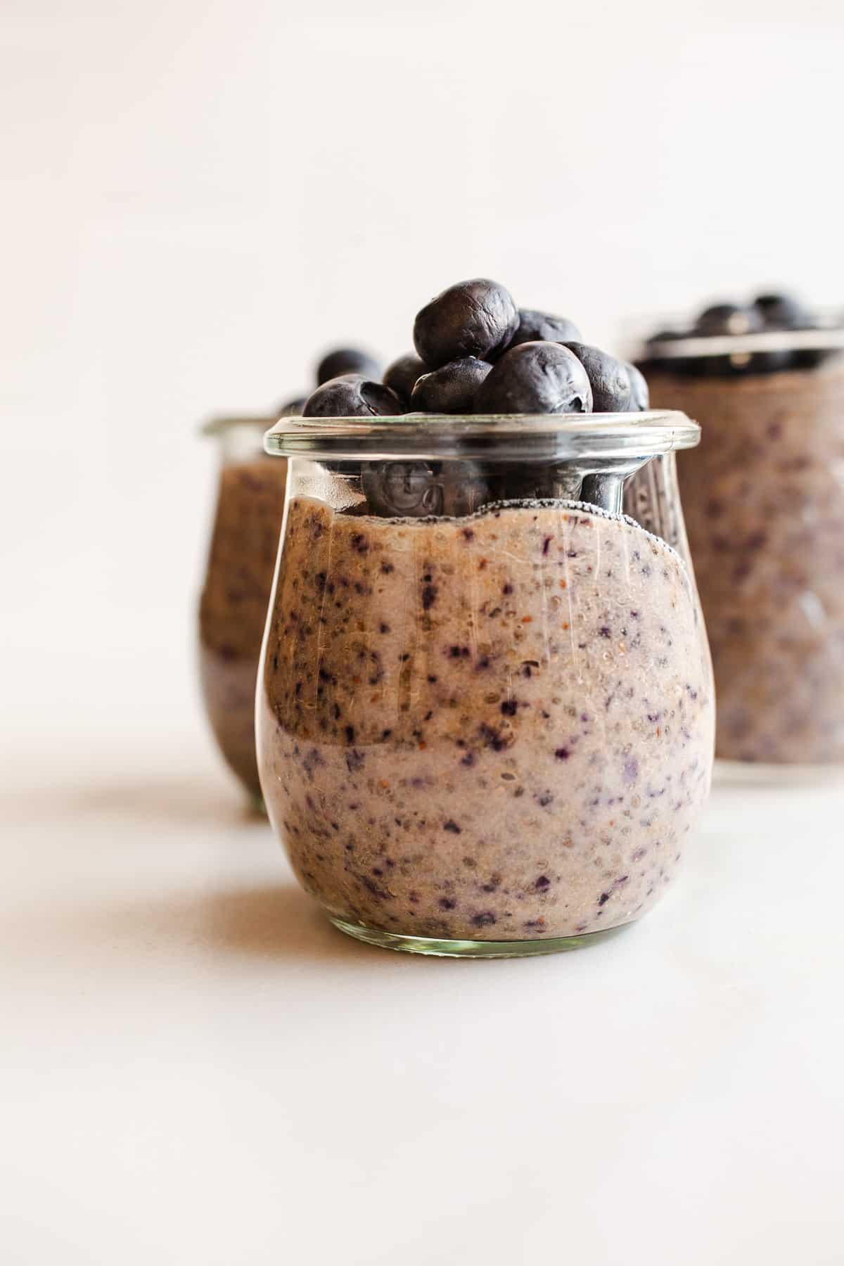 Blueberry chia pudding in mason jars topped with blueberries.