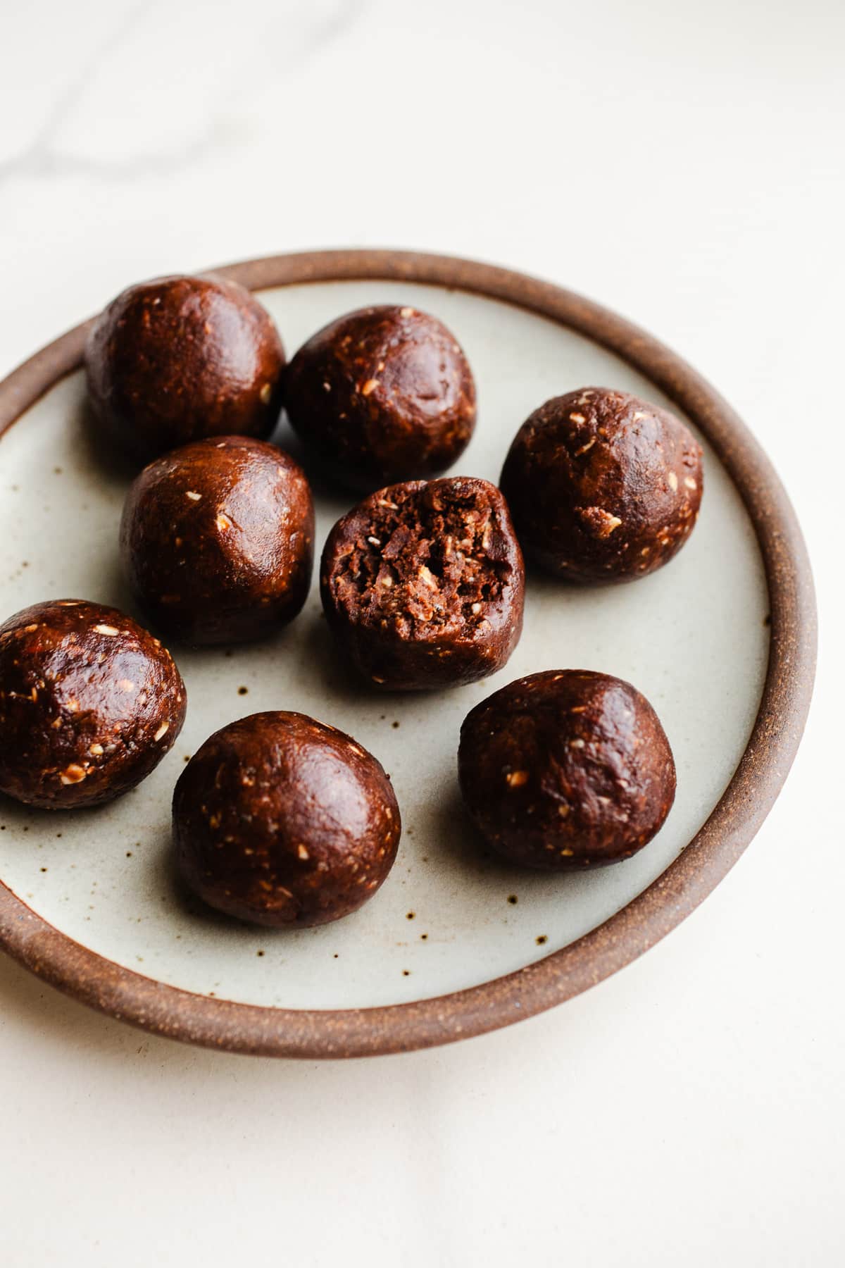 Chocolate protein balls on a plate.
