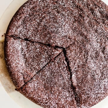 Chocolate cake dusted with powdered sugar.