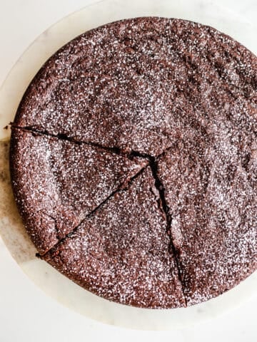 Chocolate cake dusted with powdered sugar.