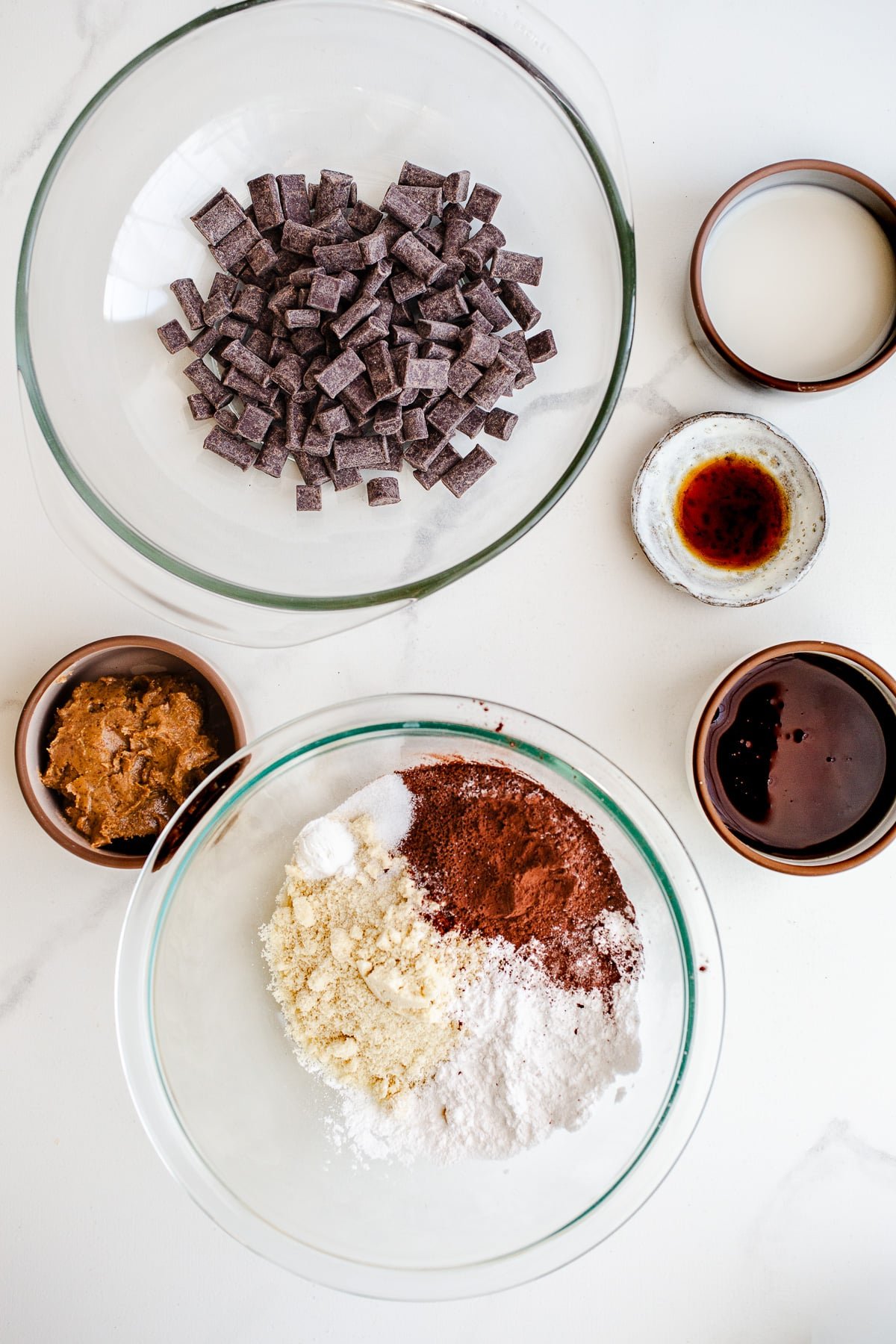 Ingredients to make flourless chocolate cake in bowls.