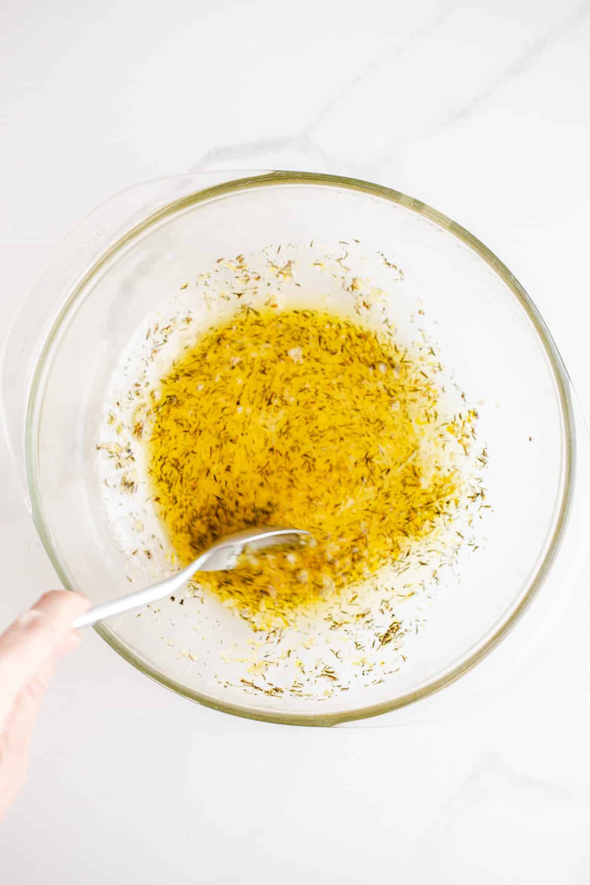 Olive oil mixture in a glass bowl. 