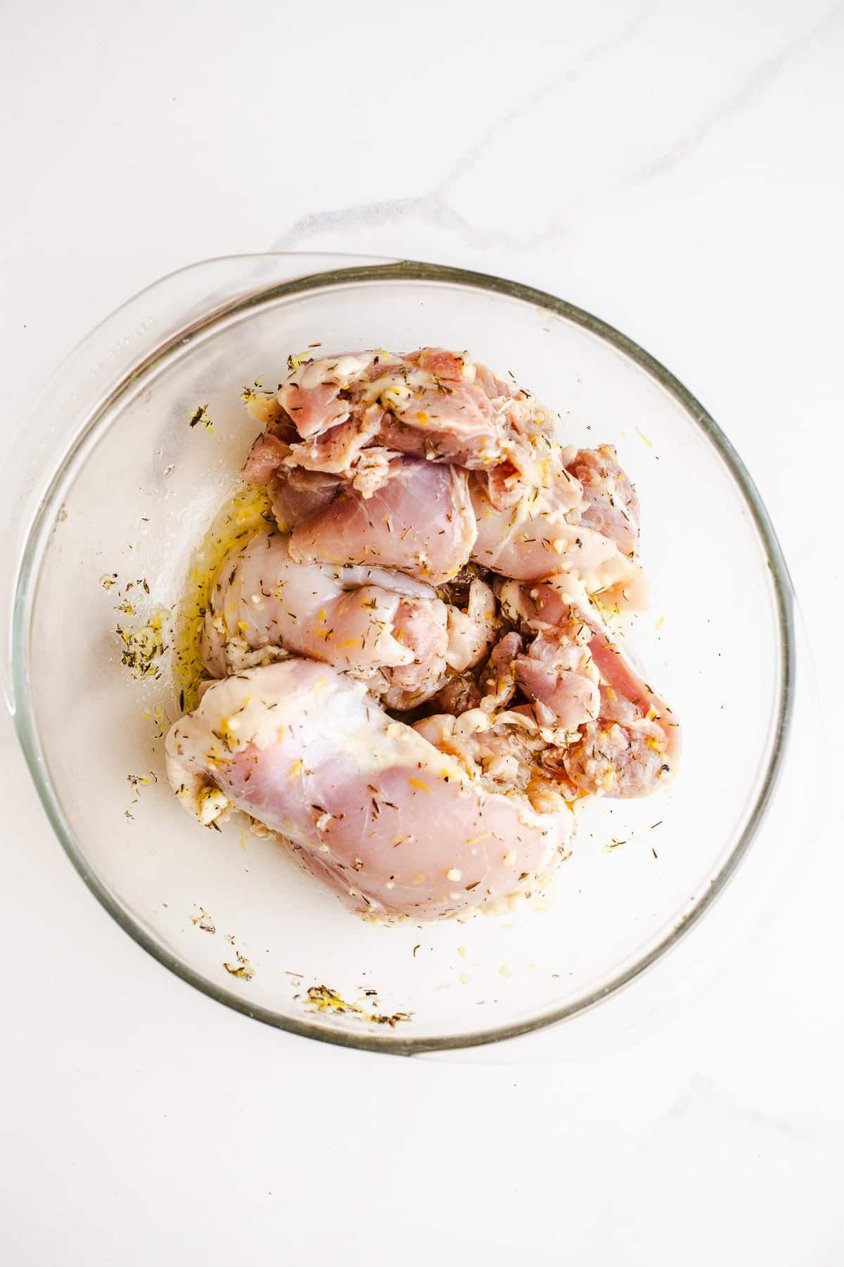 Raw chicken in a bowl with olive oil 