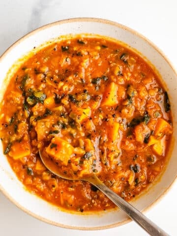 Red lentil soup and vegetables in a bowl.
