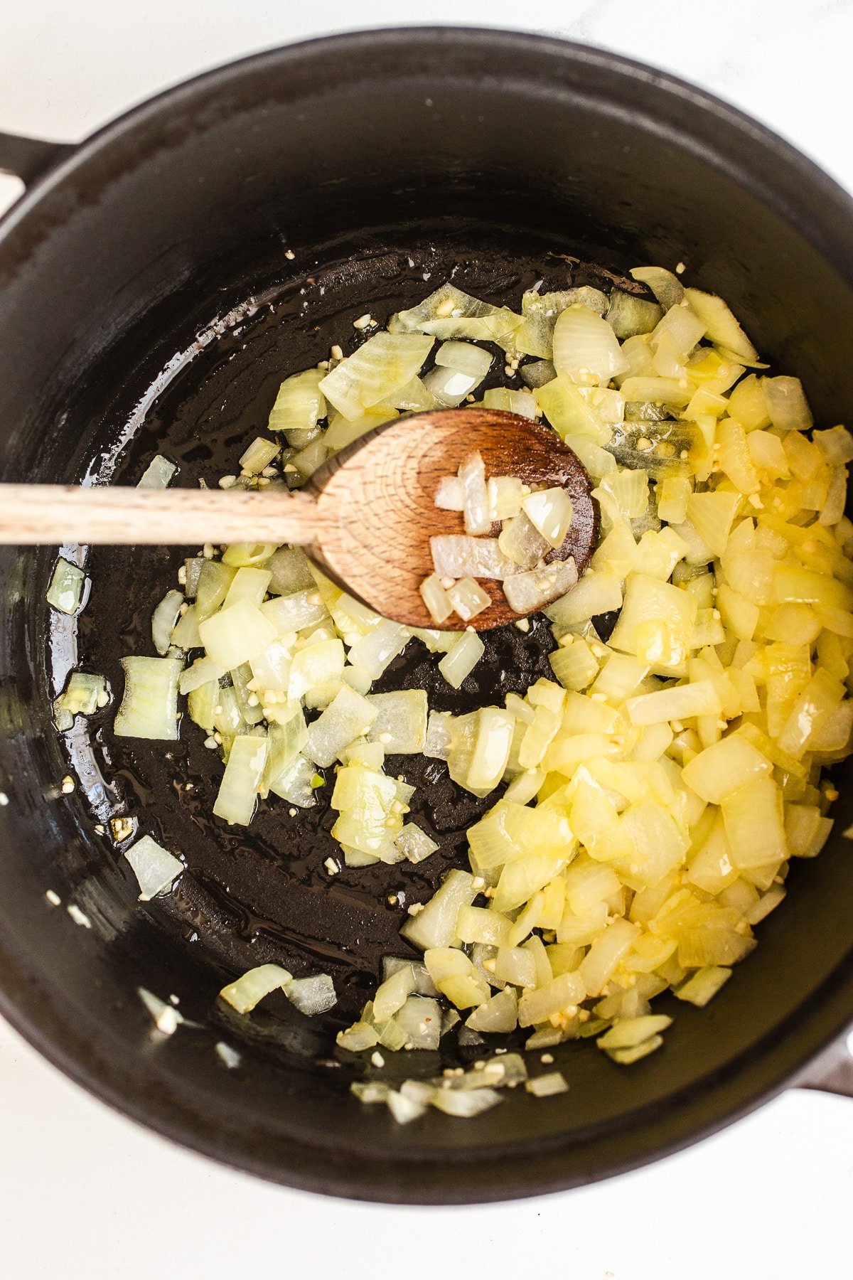 Diced onion sauteing in a pot.