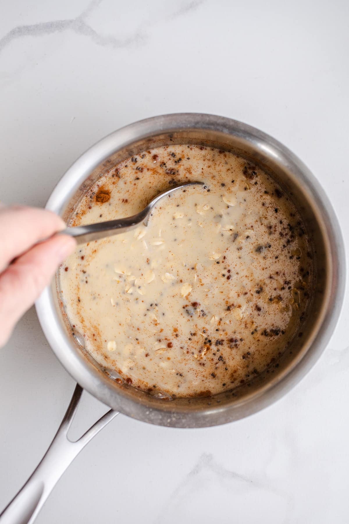 Oats and milk in a saucepan.