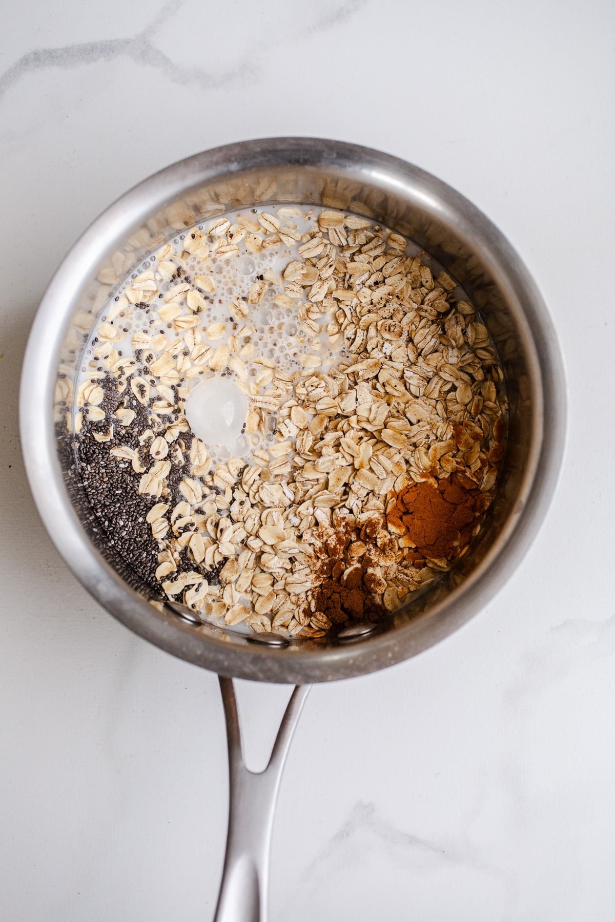 Oats and spices in a saucepan.