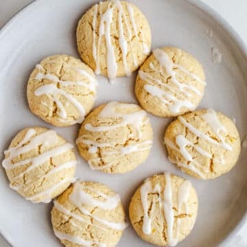 Iced lemon cookies on a plate.