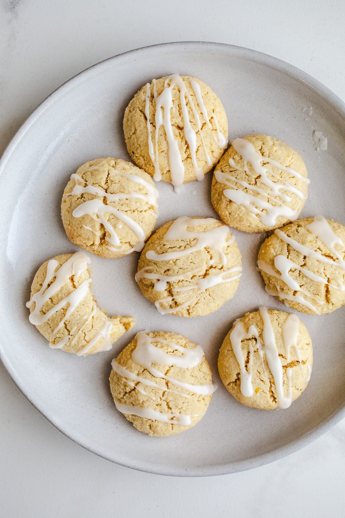 Lemon cookies with icing on a plate.