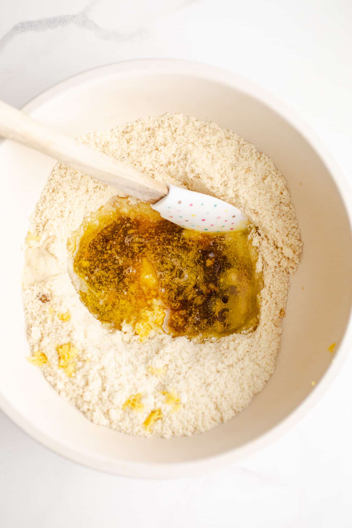Ingredients to make almond flour cookies in a mixing bowl.