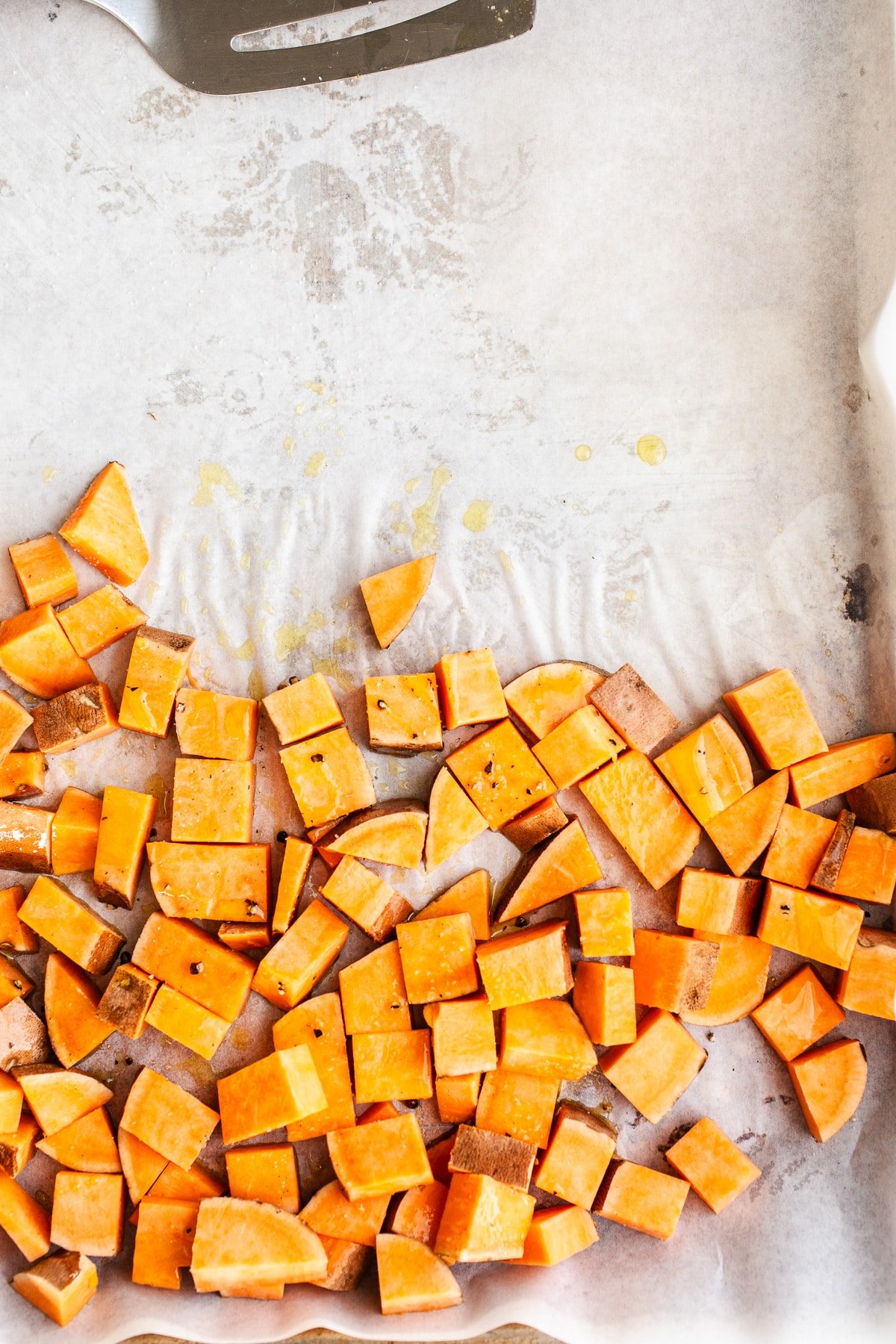 Sweet potatoes on a sheet pan.