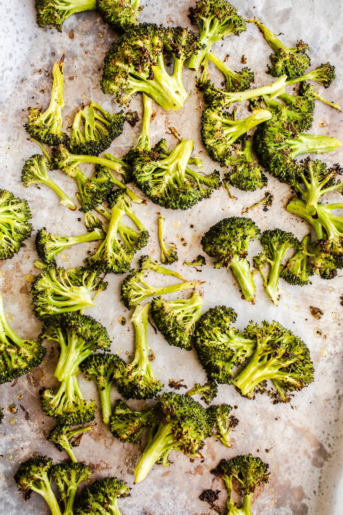 Roasted broccoli on a sheet pan.