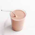 A chocolate smoothie with a metal straw.