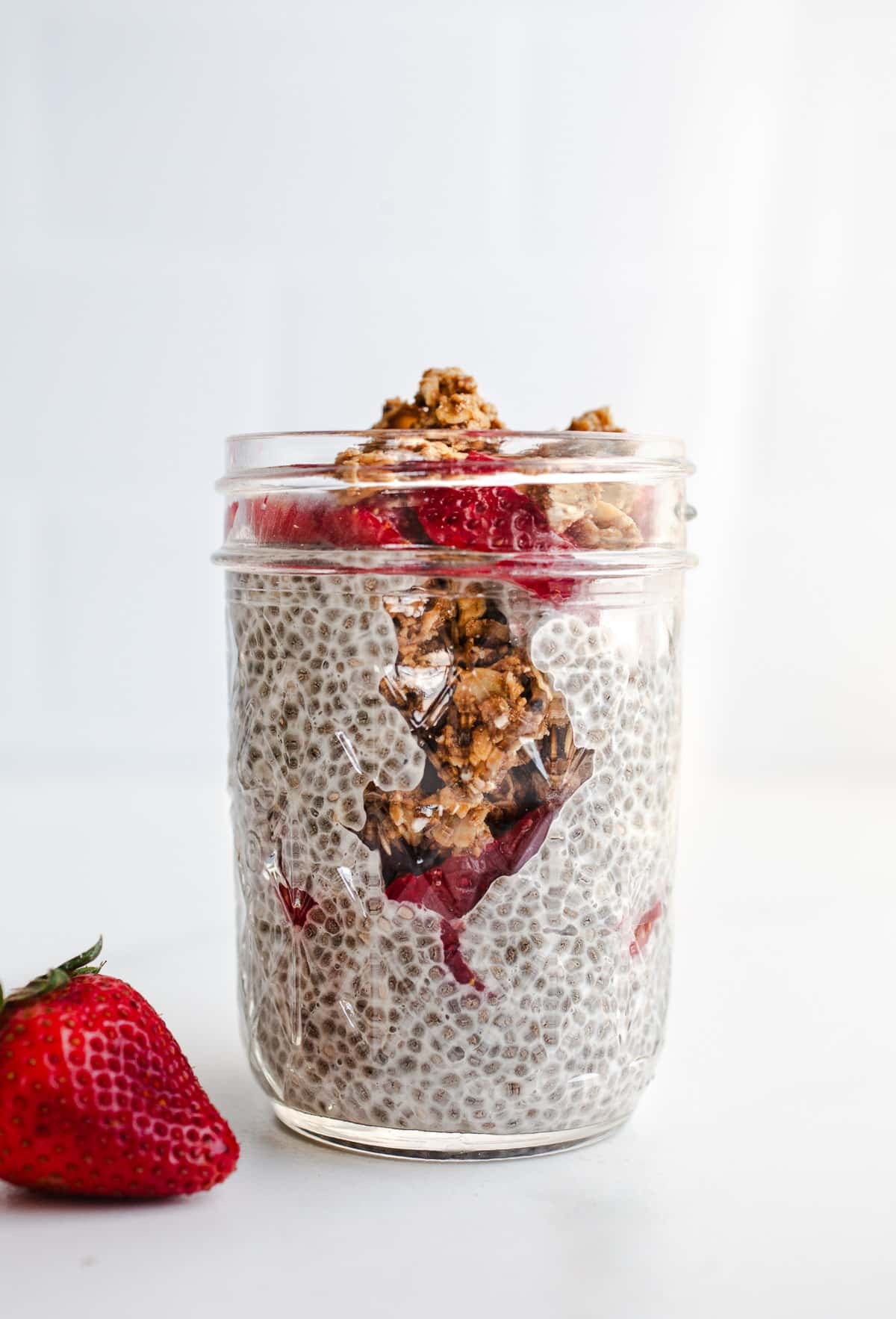 A strawberry chia parfait in a mason glass.