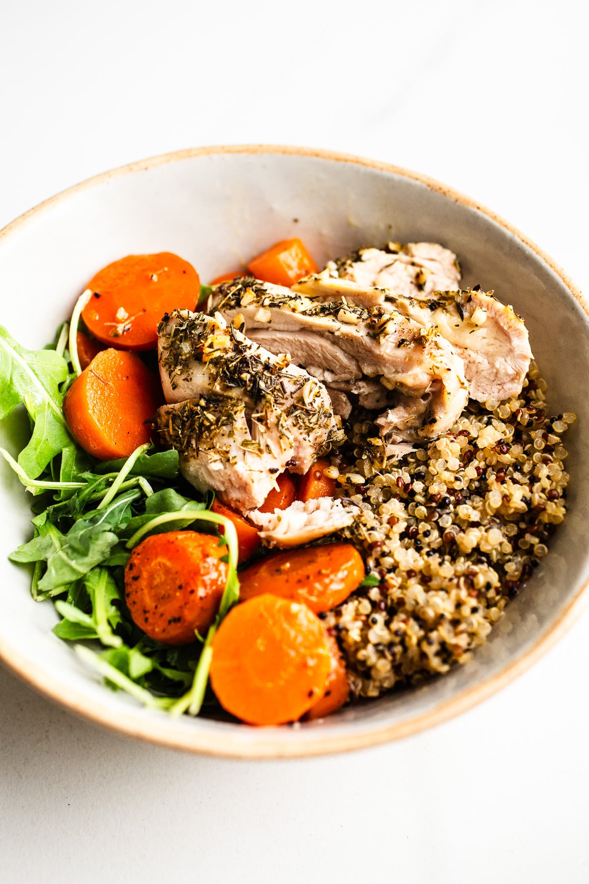 Chicken, carrots, and quinoa in a bowl.