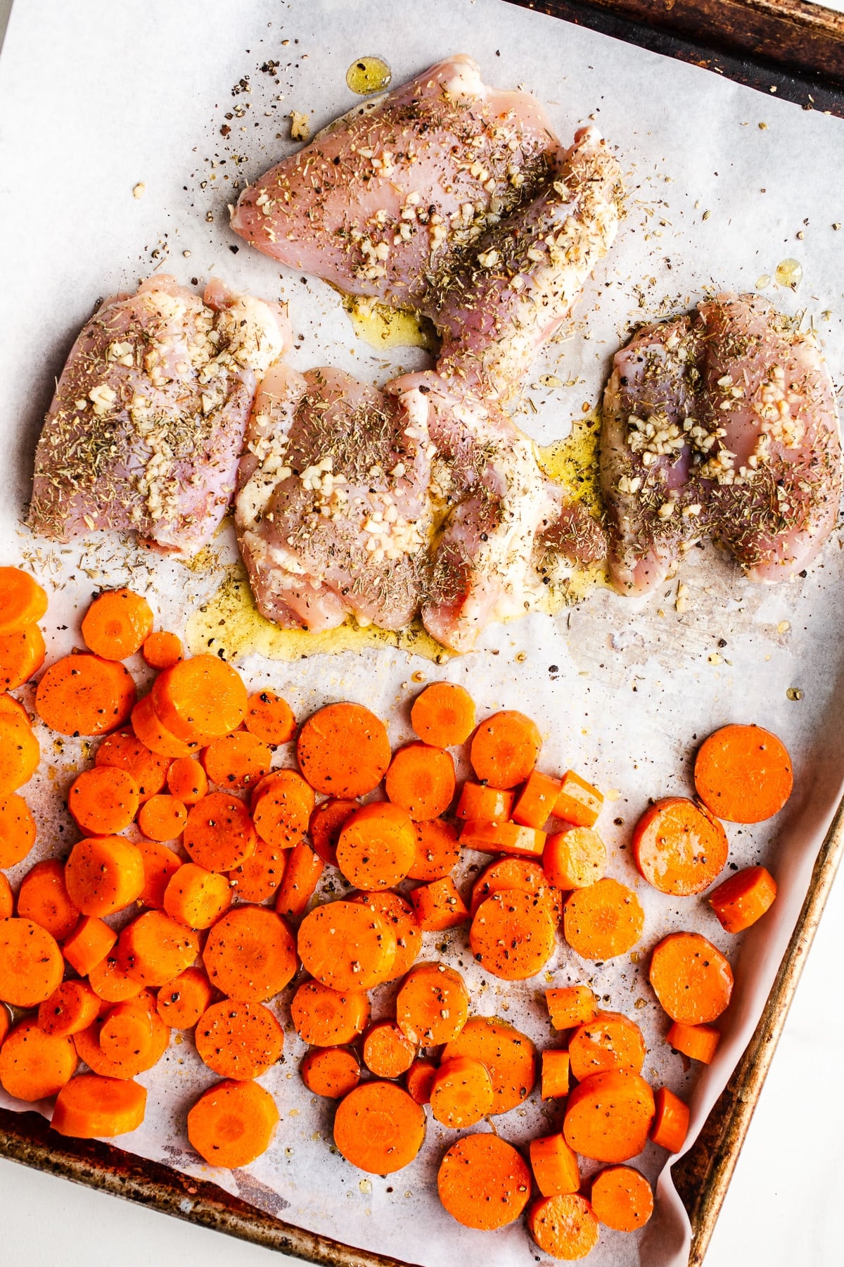 Chicken and carrots on a sheet pan.