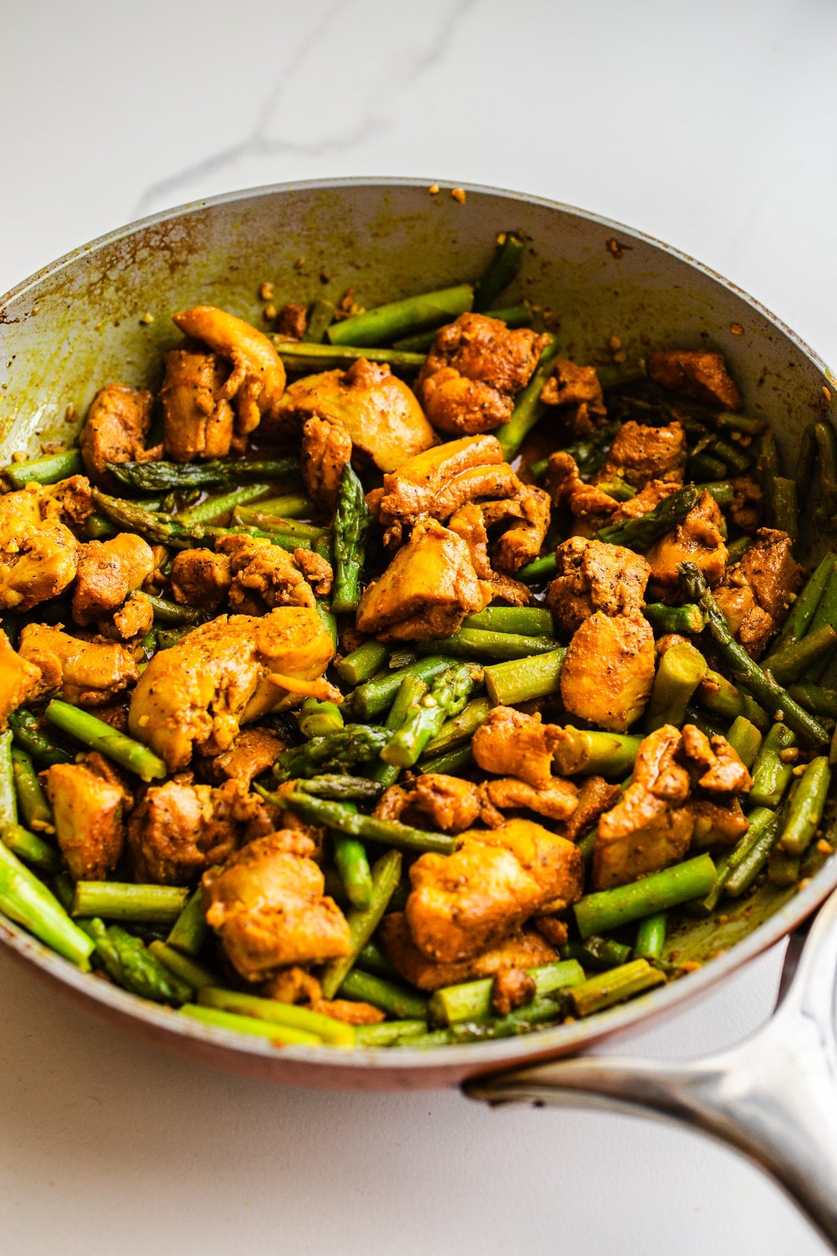 Asparagus and chicken in a pan.