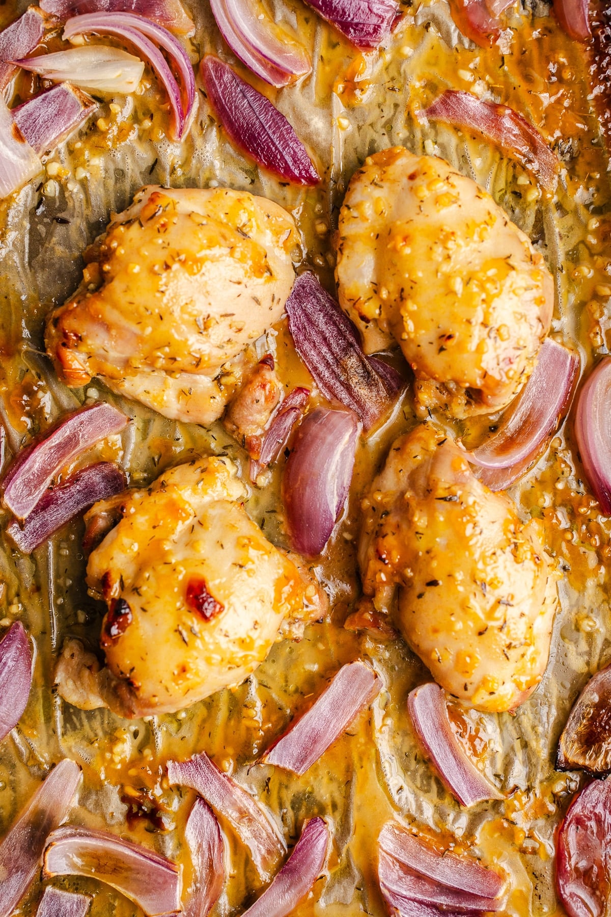 Baked apricot chicken on a sheet pan.