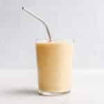 A peach smoothie in a glass.