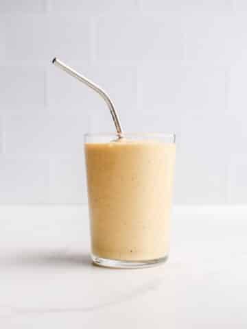 A peach smoothie in a glass.