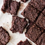 Chocolate brownie bars on parchment paper.