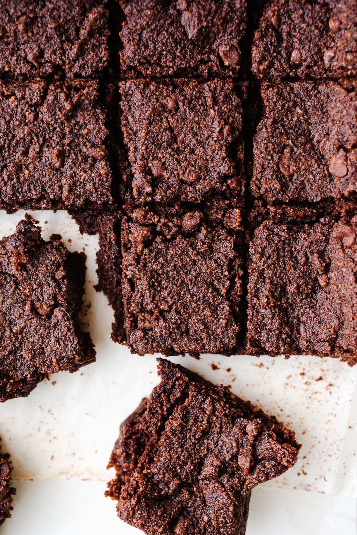 Slice chocolate bars on parchment paper.