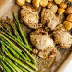 Potatoes, chicken, and asparagus on a sheet pan.