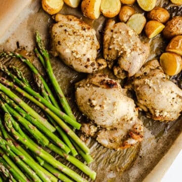 Potatoes, chicken, and asparagus on a sheet pan.