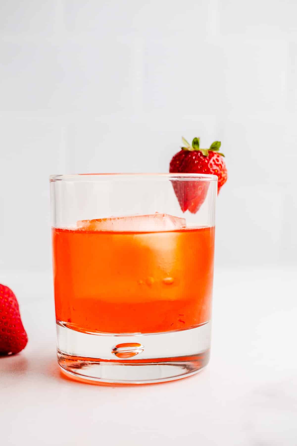 A strawberry cocktail in a rocks glass.
