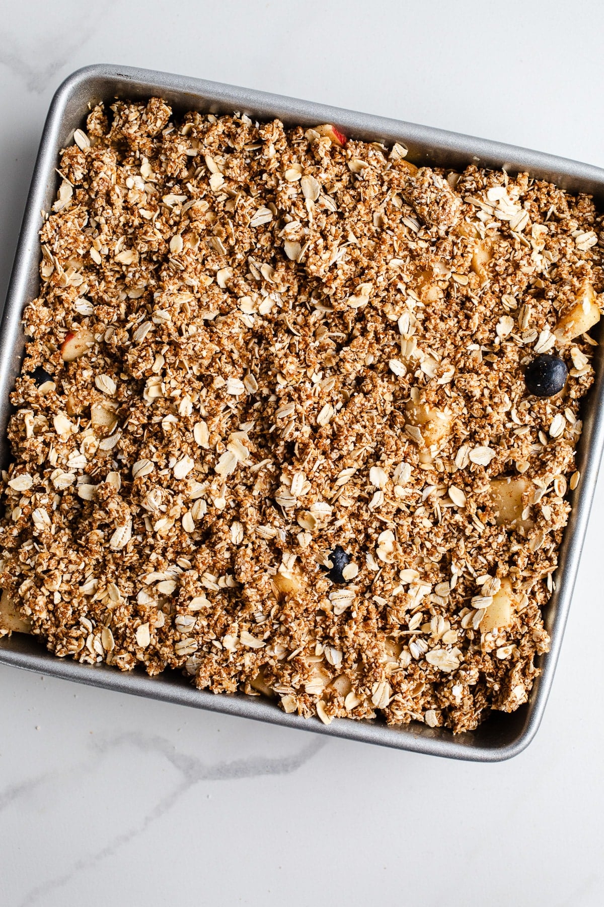 Unbaked crumble in a baking dish.