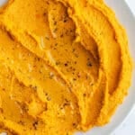 Carrot hummus in a bowl.