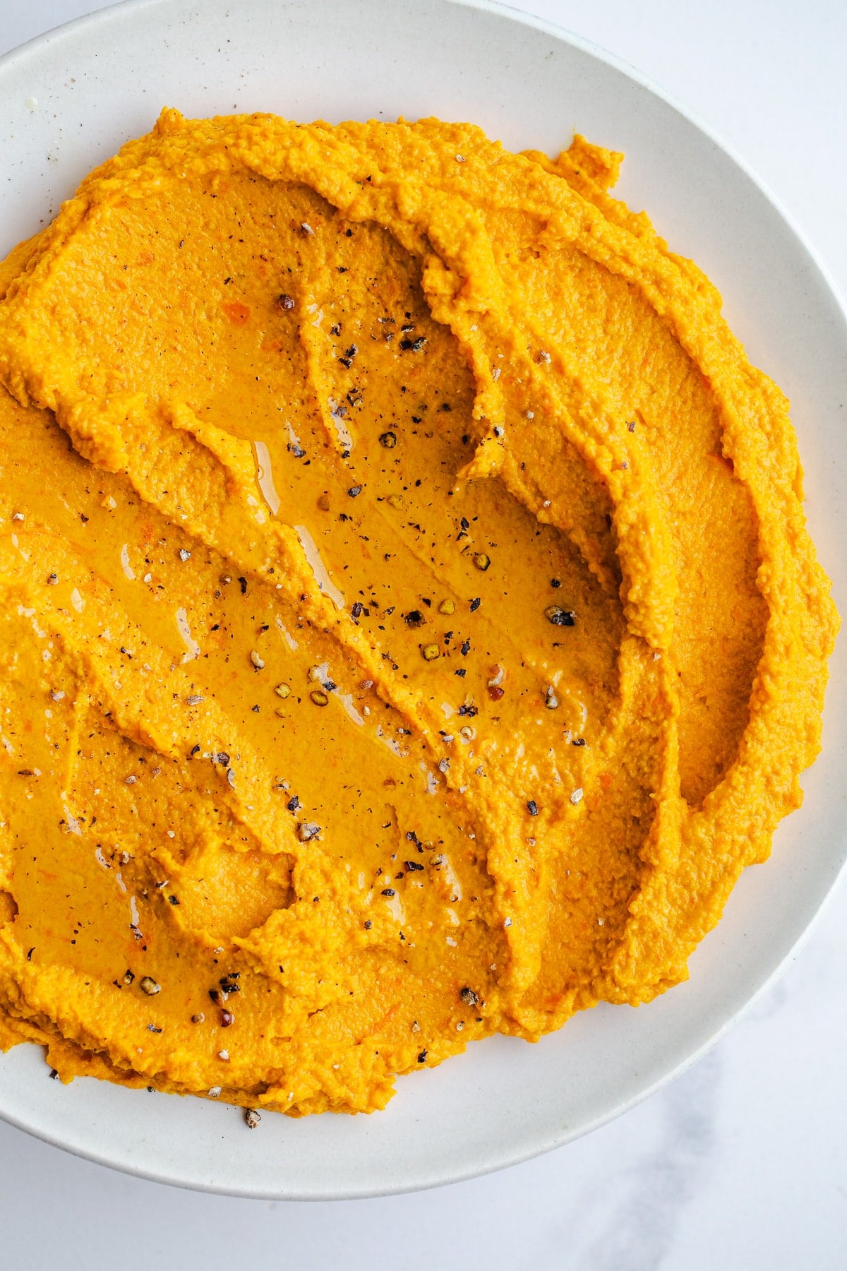 Carrot hummus in a bowl.