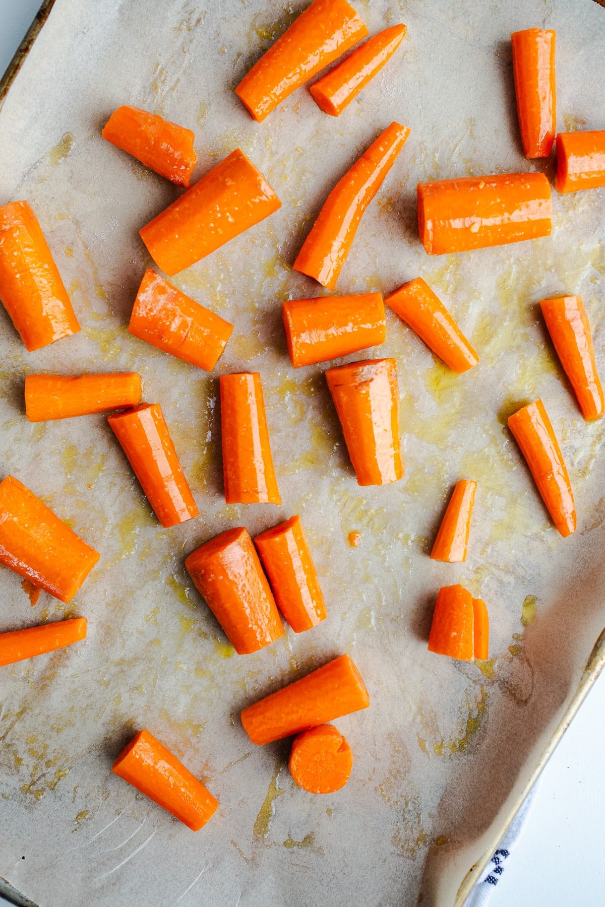 Raw carrots on a sheet pan.