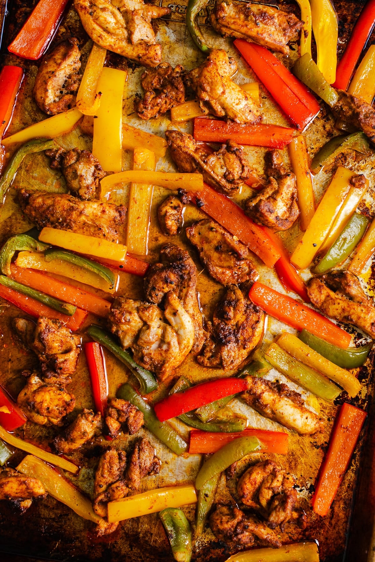 Fajita chicken and bell peppers on a sheet pan.