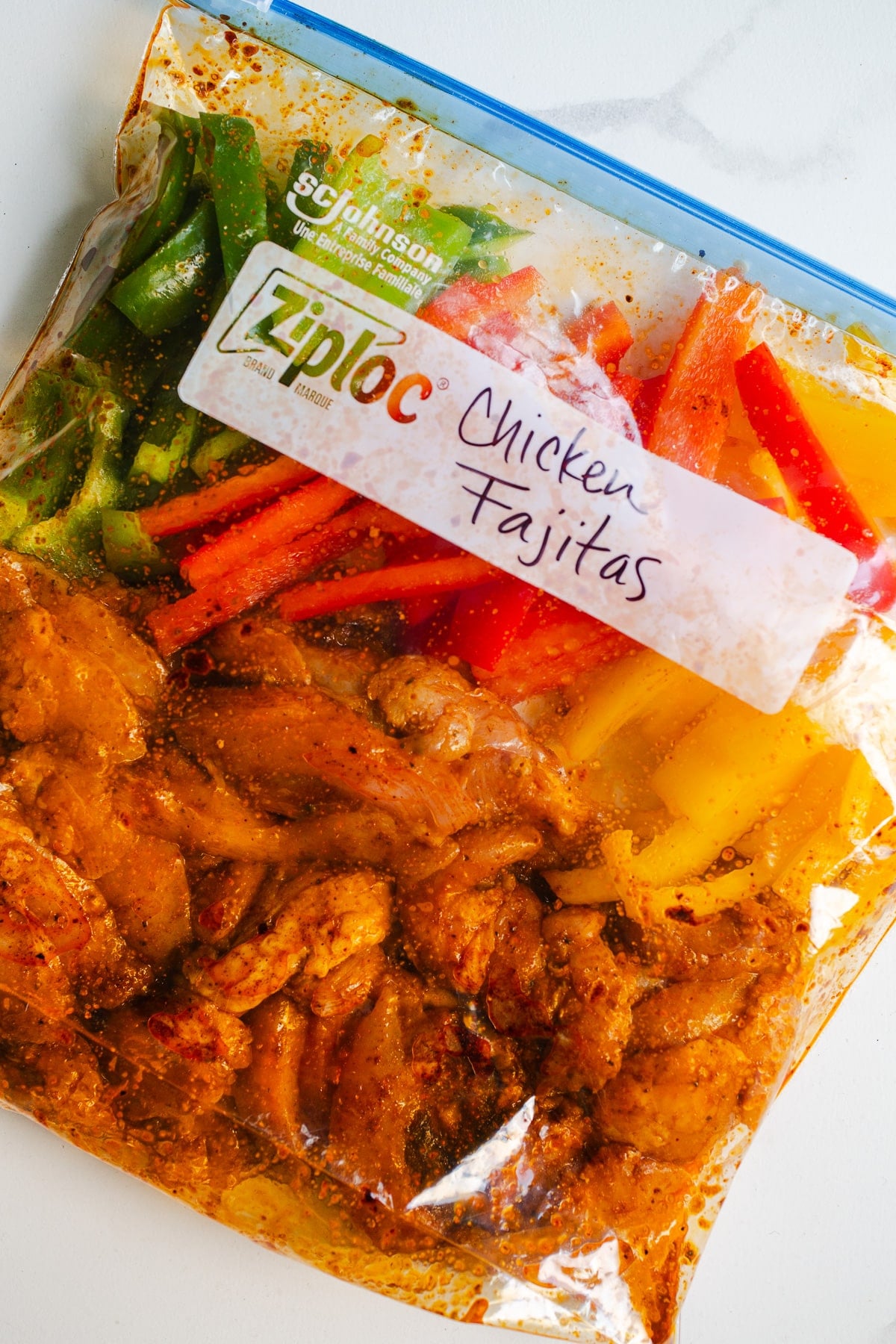 Chicken and bell peppers in a ziplock bag.