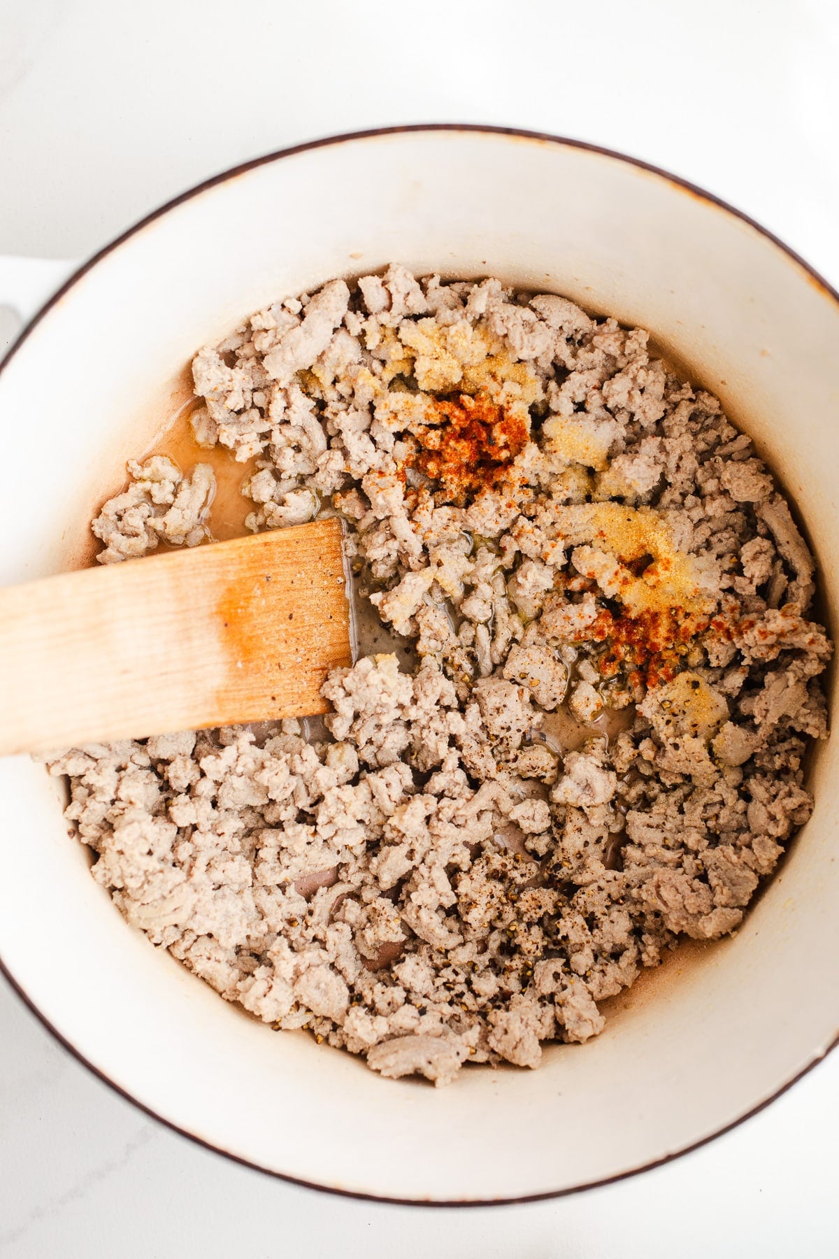 Ground turkey and seasonings in a pot.
