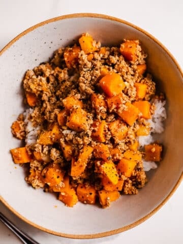 Turkey sweet potato skillet over rice in a bowl.