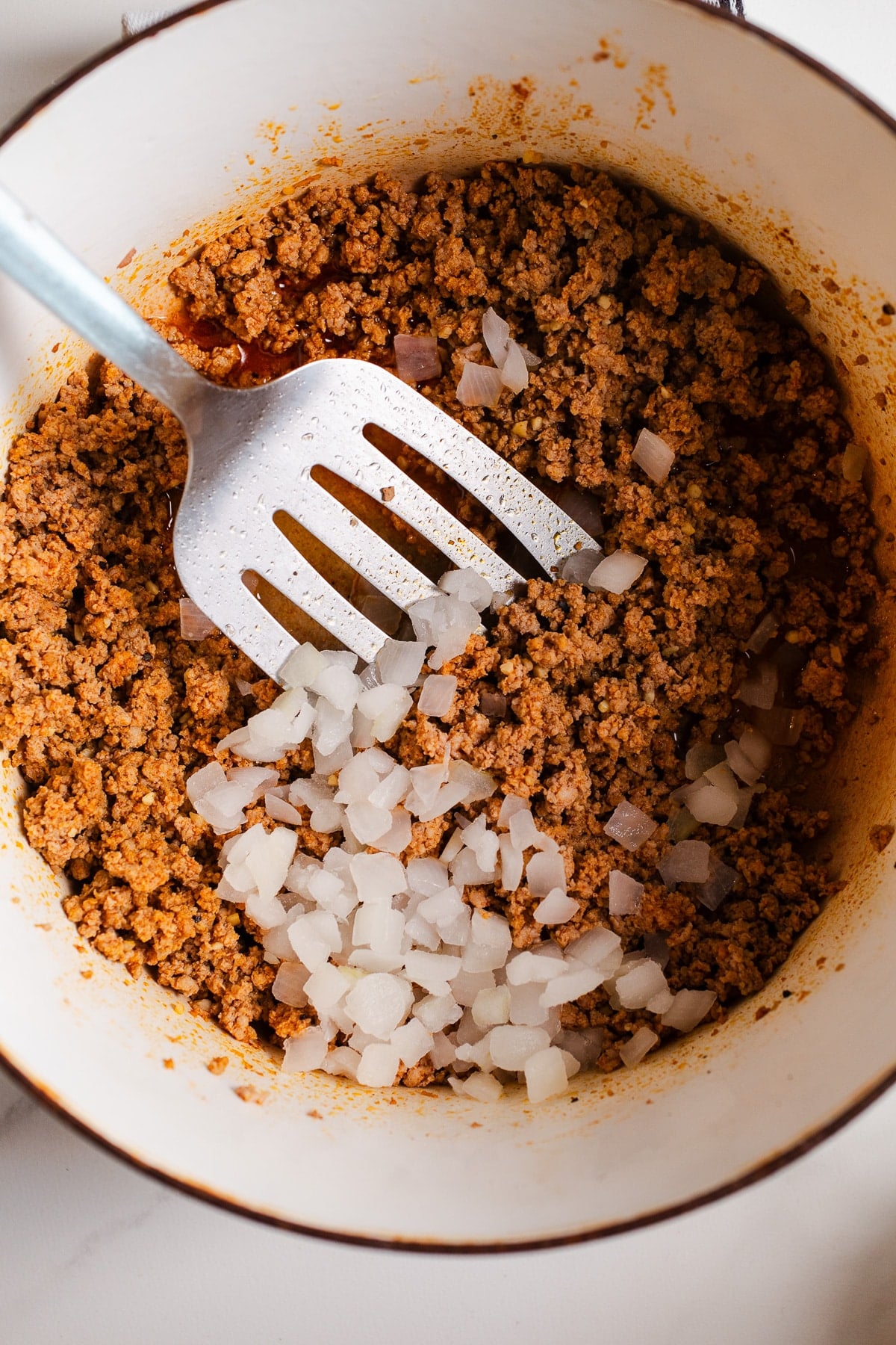 Ground turkey in a large pot.