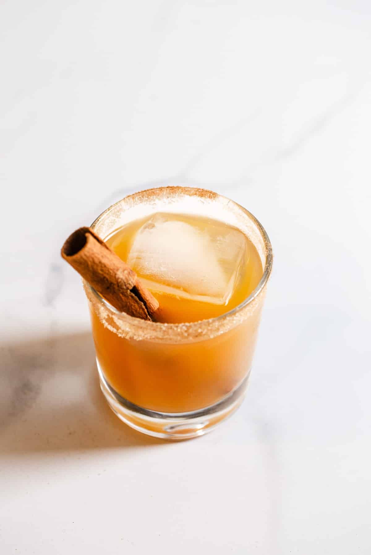 Apple cider cocktail with a cinnamon stick.